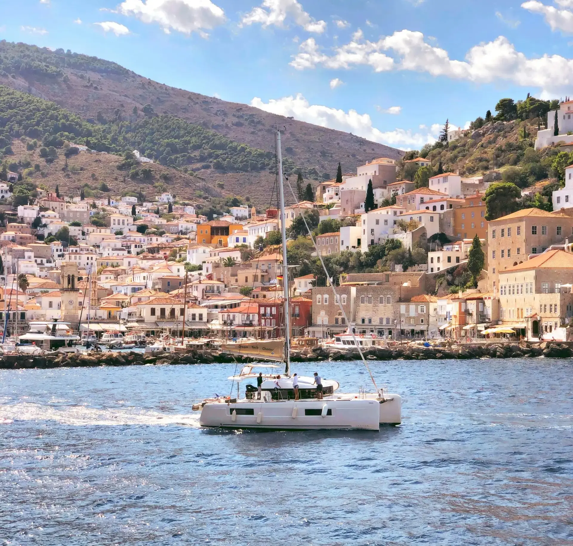 catamaran sailing in front of the port of Hydra Greece