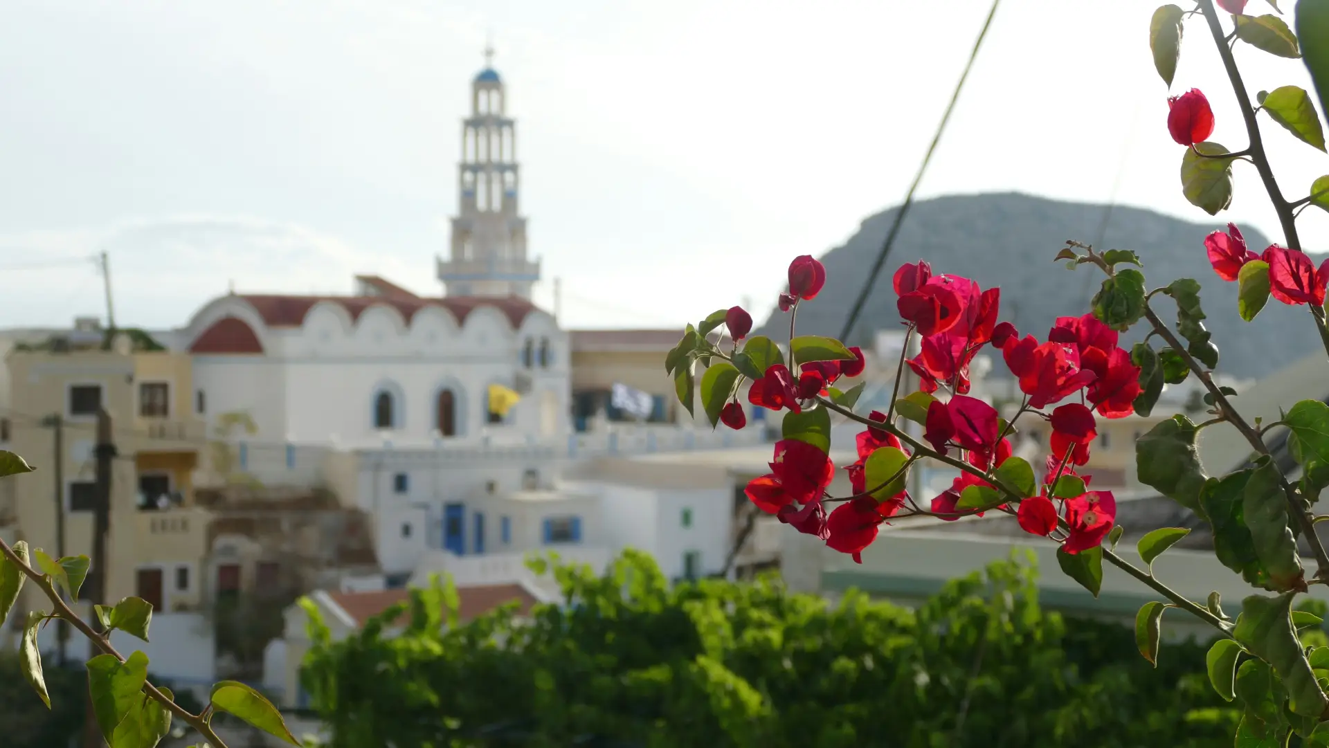 Greece in April: What the Experience Actually Feels Like 4 view of a church through blossomed Bougainvillea in Karpathos Greece