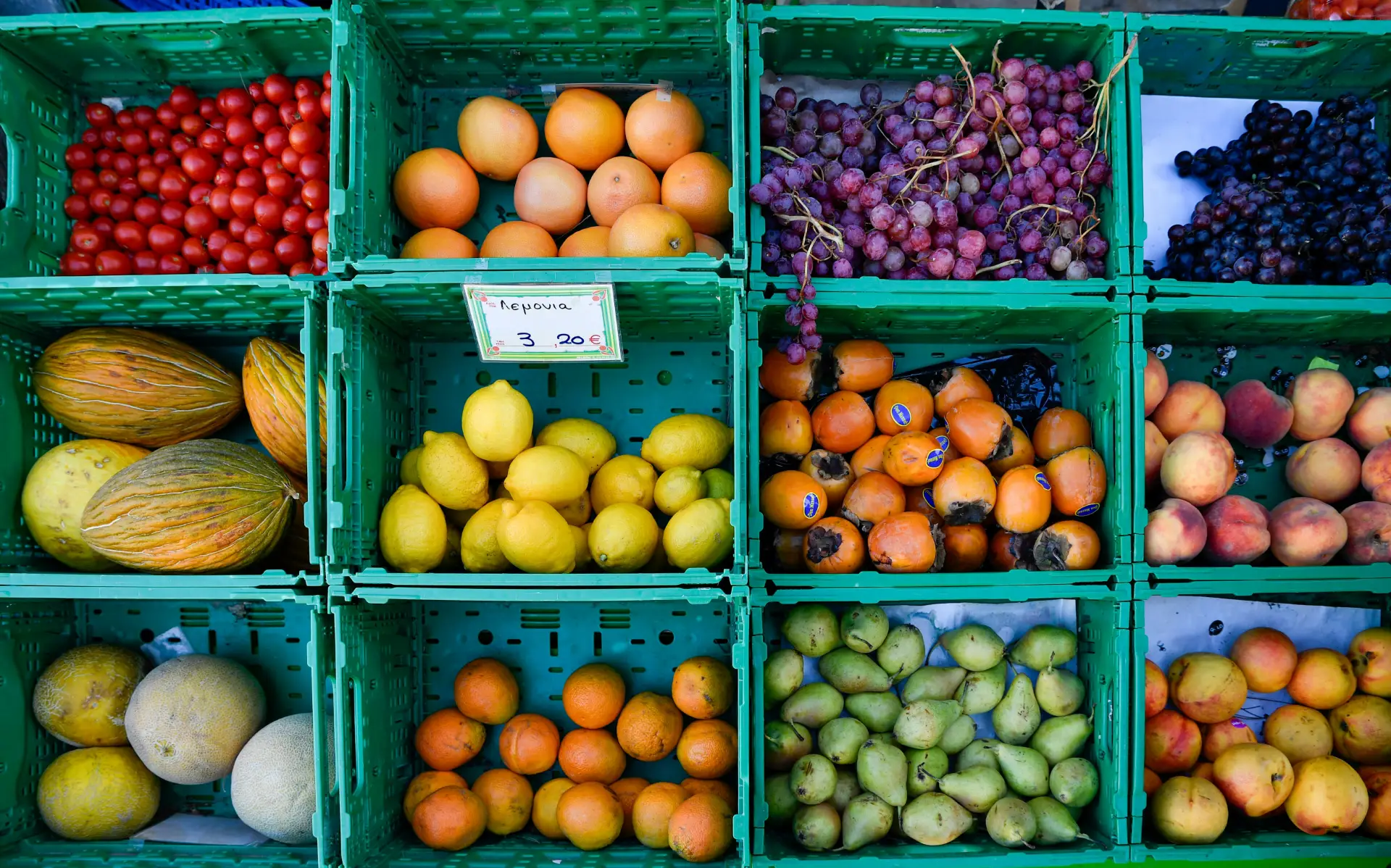 eight crates with different kind of greek fruits 