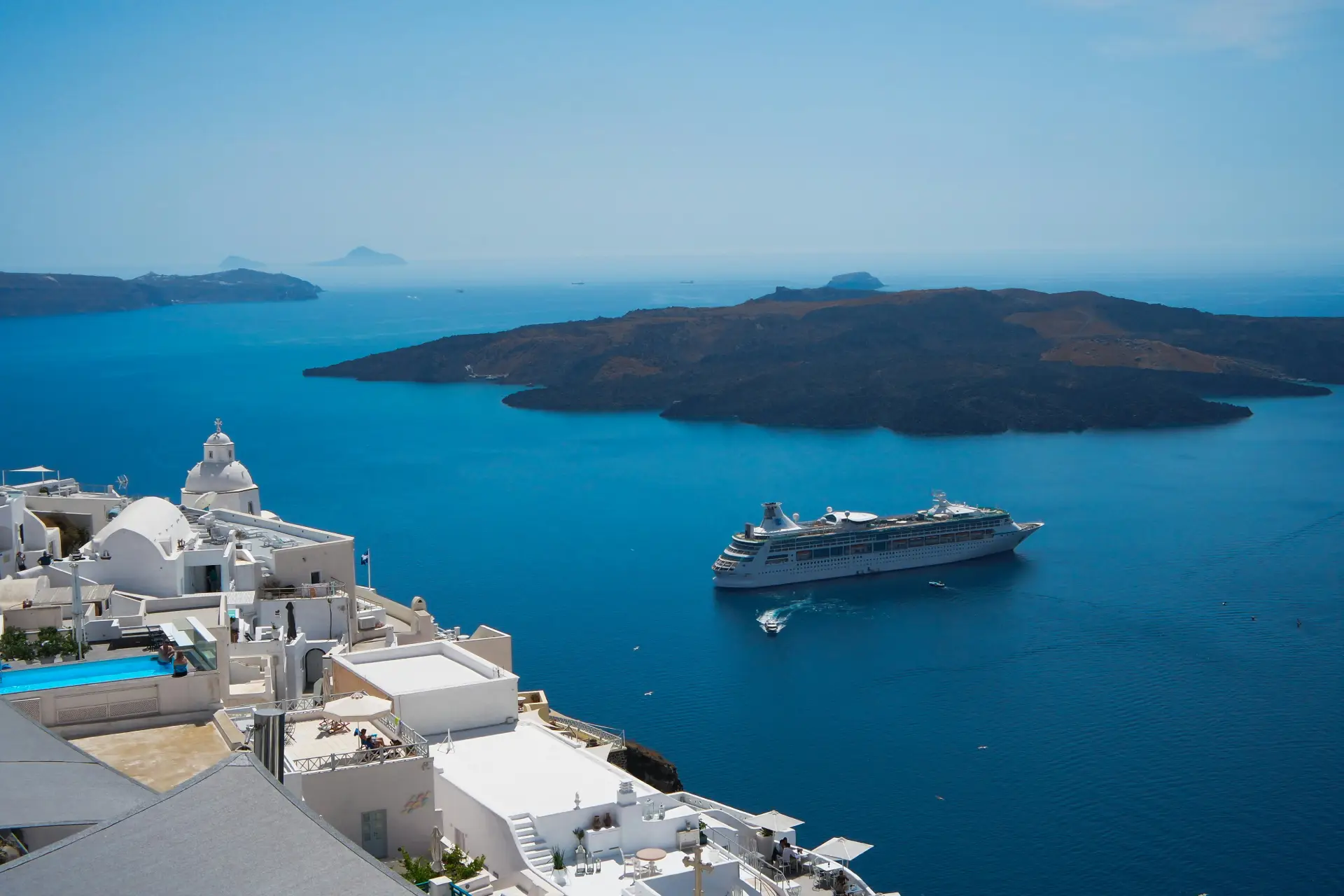 caldera santorini with a cruise ship on the water