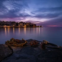 harbor of Chania at dusk, with the lighthouse at the background