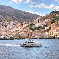 catamaran sailing in front of the port of Hydra Greece