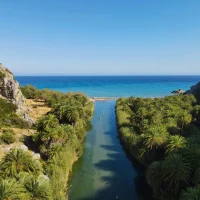 aerial view of Preveli beach the river crossing Palm trees